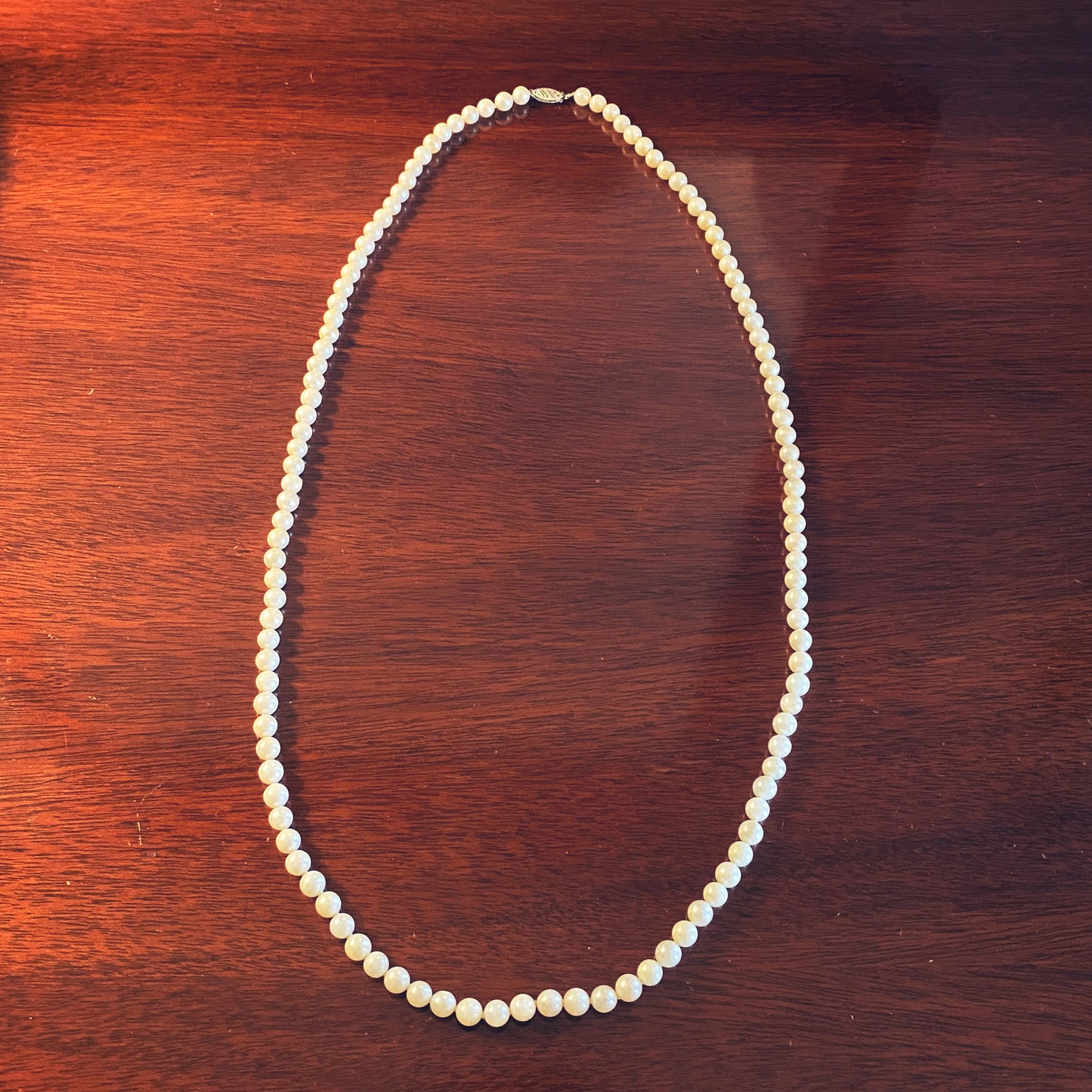 Long strand vintage faux pearl necklace with gold clasp