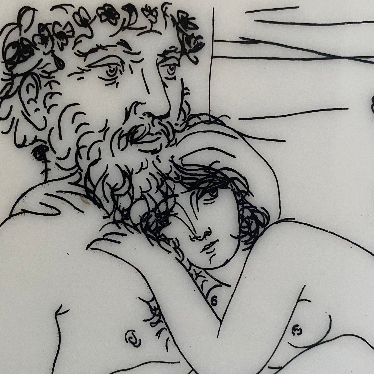 This ceramic tile is a reproduction of Pablo Picasso’s Sculptor at Rest with His Model, Anemones and Small Torso from the Vollard Suite. Showing a close up of faces.
