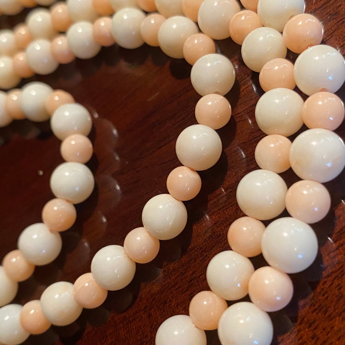 Long strand pink and white coral beaded necklace