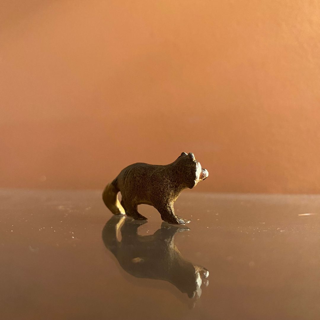 painted metal raccoon miniature back