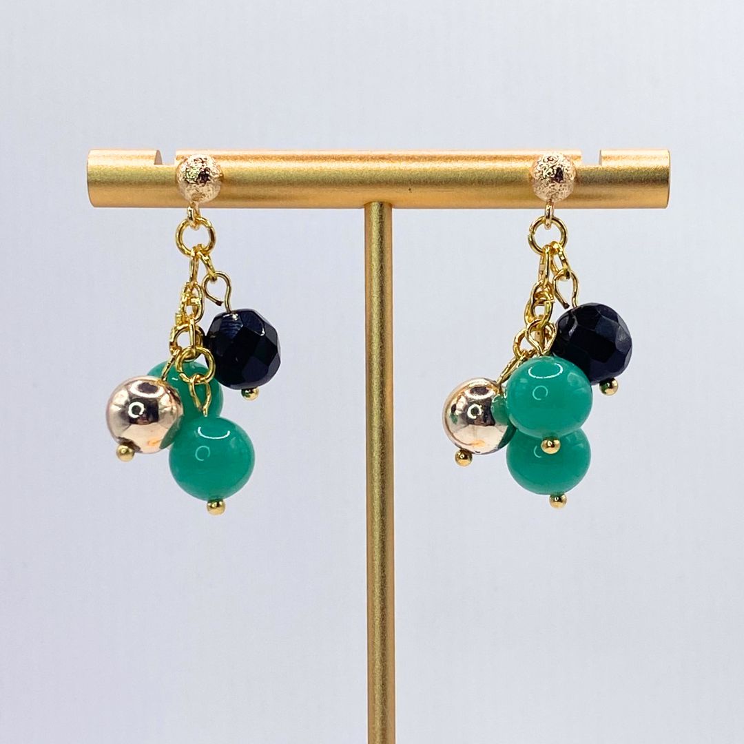 Vintage reclaimed gold plated earrings Close up teal black and gold 