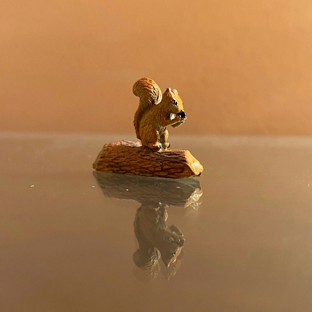 vintage painted metal miniature chipmunk on a log