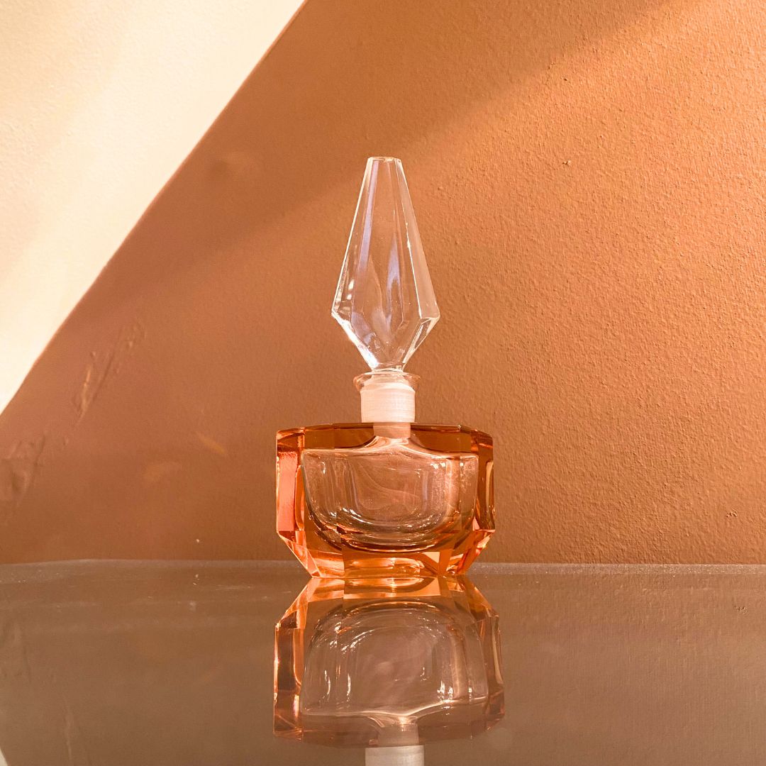 vintage pale pink crystal perfume bottle close up view